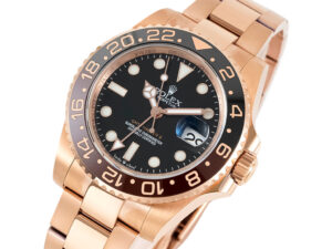 GMT-Master II Rose Gold 'Root Beer' (40mm) watch with black dial, two-tone bezel, and oyster bracelet displayed at an angle.