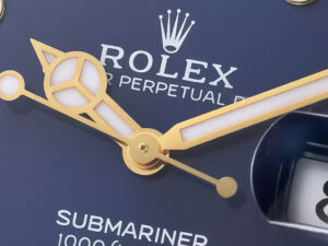 Close-up view of the Submariner Date Yellow Gold with Blue Dial (40mm), showcasing its detailed dial design and gold accents.