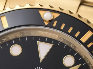 Close-up of the Submariner Date Yellow Gold with Black Dial (40mm), showcasing its detailed bezel and hour markers.