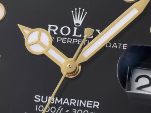 Close-up view of black dial on the Submariner Date Yellow Gold (40mm) showcasing gold hands and date display at 3 o'clock.