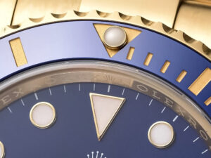 Close-up of the Submariner Date Yellow Gold with Blue Dial (40mm), showcasing detailed bezel and luminescent hour markers.