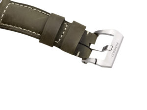 Close-up of the clasp and olive green leather strap for Luminor 1950 44 3 Days Automatic, showcasing "Panerai" engraving.