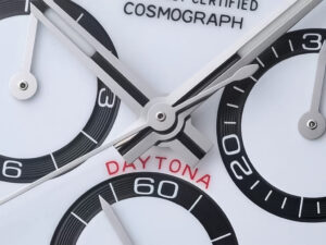 Close-up of the Cosmograph Daytona Stainless Steel ‘Panda’ (2023) watch face, featuring black subdials, red "Daytona" text.