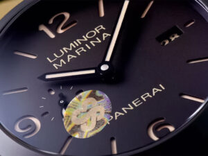 Close-up of Luminor 1950 Marina 3 Days Automatic Aluminium watch face with black dial and luminous details.