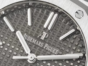 Close-up of the grey dial of the Royal Oak Stainless Steel watch (37mm) featuring a textured pattern and silver hour markers.