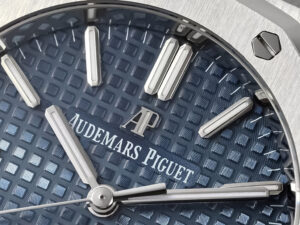 Close-up view of the Royal Oak 37mm watch in stainless steel, featuring blue dial with logo and silver-tone hands.