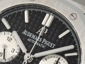 Close-up of the Royal Oak Chronograph Stainless Steel 41mm with black dial, showcasing its detailed design and branding.