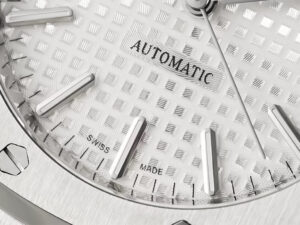 Close-up of the Royal Oak Stainless Steel 37mm watch with a silver dial featuring "Automatic" text and Swiss-made markers.