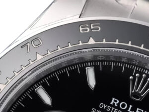Close-up of the Cosmograph Daytona Stainless Steel (2023) showing black dial, bezel with tachymeter scale, and steel case.