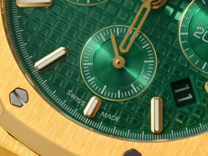 Close-up of the Royal Oak Chronograph Yellow Gold with Green Dial (41mm) showcasing detailed textures and Swiss Made mark.