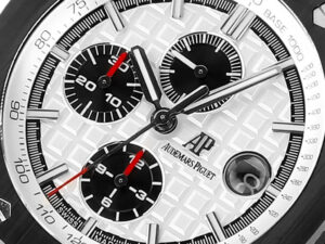 Close-up of Royal Oak Offshore Chronograph Stainless Steel watch, silver dial, black subdials, red accents, and date display.