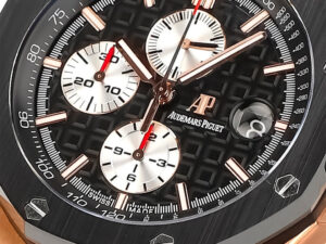 Close-up of Royal Oak Offshore Chronograph in pink gold, featuring a black dial with white subdials and bold red accents.