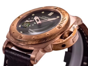 Luminor Submersible 1950 watch with green dial, titanium and bronze case, and brown leather strap (47mm), close-up view.