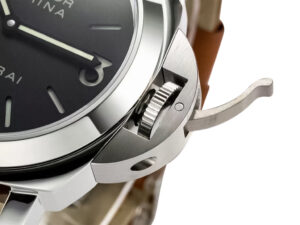 Close-up of the Luminor Marina Stainless Steel watch with a black dial, highlighted crown guard, and brown strap (44mm).