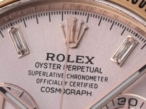 Close-up view of the Cosmograph Daytona Rose Gold with Diamond Pink Dial, showcasing the  crown logo and watch details.