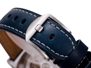 Close-up of Luminor 1950 3 Days GMT Automatic Acciaio watch's blue leather strap with white stitching and steel buckle.