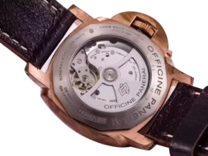 Back view of Luminor Submersible 1950 3 Days Automatic Titanium and Bronze with visible mechanical movement and brown strap.