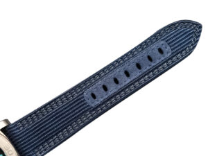 Close-up view of the blue recycled PET strap with multiple adjustment holes, part of the Luminor Submersible 47 'Mike Horn Edition'.