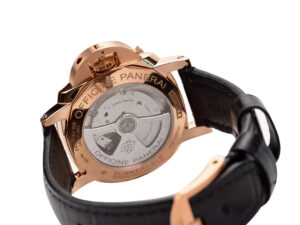 Rear view of Luminor Submersible 42 Goldtech watch showcasing red gold case back, visible movement, and black leather strap.