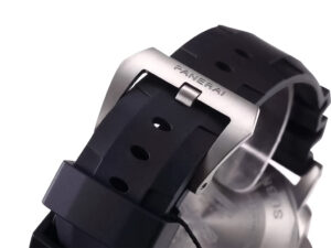 Close-up of the Luminor Submersible 47 strap buckle engraved with "Panerai," showing the rugged black rubber strap.