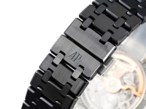 Close-up of the Royal Oak ‘Perpetual Calendar’ Ceramic watch bracelet with black finish and engraved AP logo.