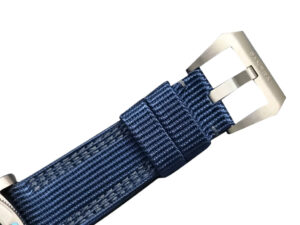 Close-up of the Luminor Submersible 47 ‘Mike Horn Edition’ watch featuring a blue strap and titanium buckle clasp.