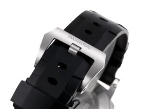Close-up of the stainless steel buckle with "Panerai" engraved, attached to the black rubber strap of watch.