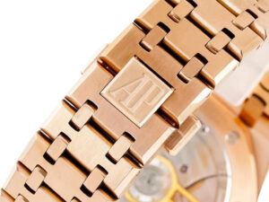 Close-up of the Royal Oak Pink Gold 41mm bracelet showcasing intricate links and the engraved AP logo near the clasp.