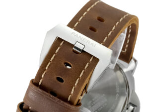 Close-up of the Luminor Marina 8 Days ‘Paneristi’ watch's brown leather strap with stainless steel clasp engraved "Panerai."