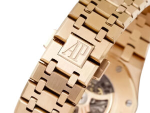 Close-up of the Royal Oak Pink Gold Openworked Double Balance Wheel's pink gold bracelet with AP logo engraving.