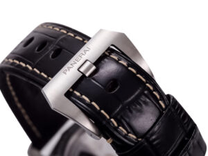 Close-up of the black leather strap with white stitching and stainless steel clasp engraved with "PANERAI" for Luminor 1950.