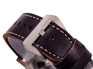 Close-up of the brown leather strap and titanium buckle of the Luminor Submersible 1950 3 Days Automatic watch.