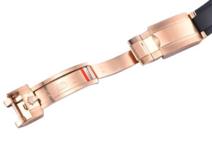 Rose gold clasp of the Cosmograph Daytona Rose Gold Oysterflex with Chocolate Dial, showcasing intricate detailing.