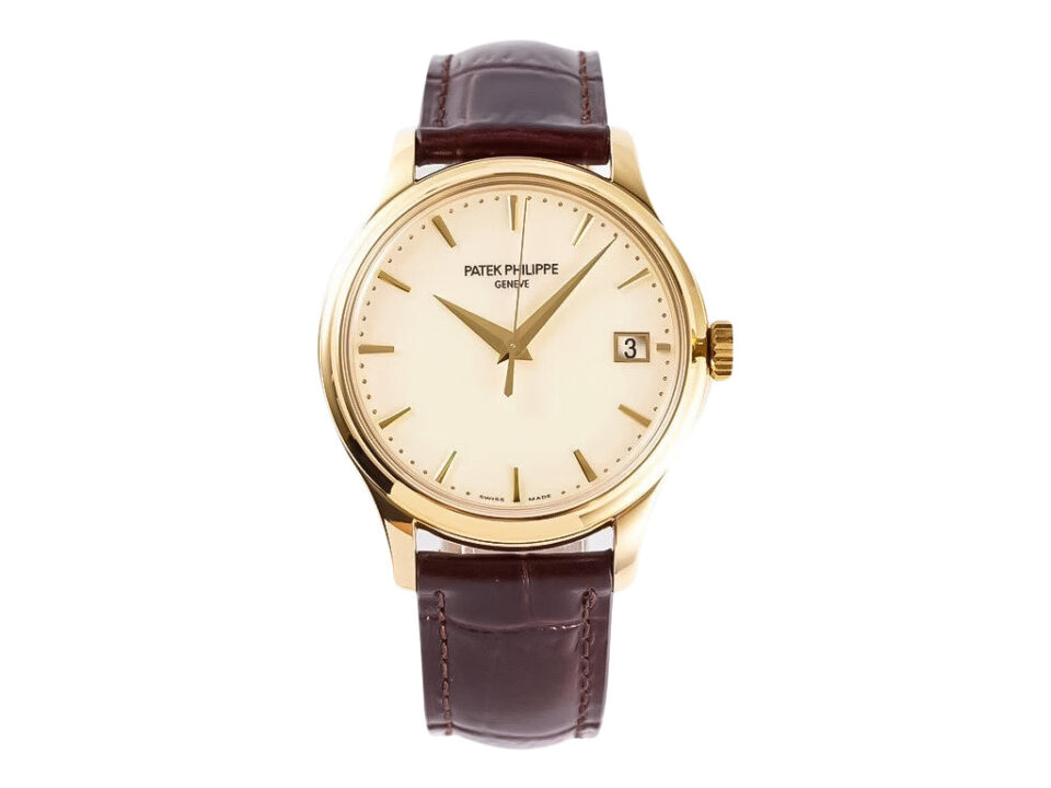 Calatrava Yellow Gold watch with 39mm ivory dial, brown leather strap, and date display at 3 o'clock.