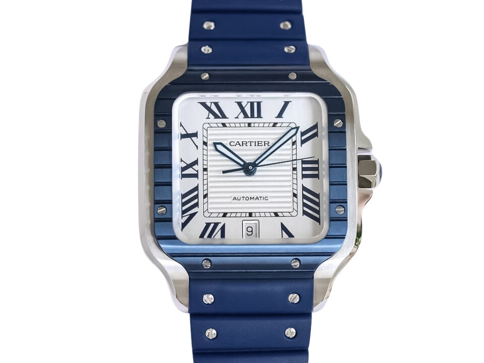 Santos Large Stainless Steel watch with white dial, blue bezel, Roman numerals, date display, and blue rubber strap (40mm).
