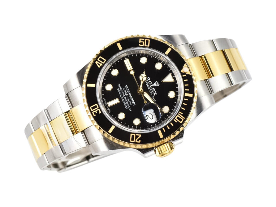 A Submariner Date 'Two Tone' watch in yellow gold and stainless steel with a black dial, displayed diagonally.