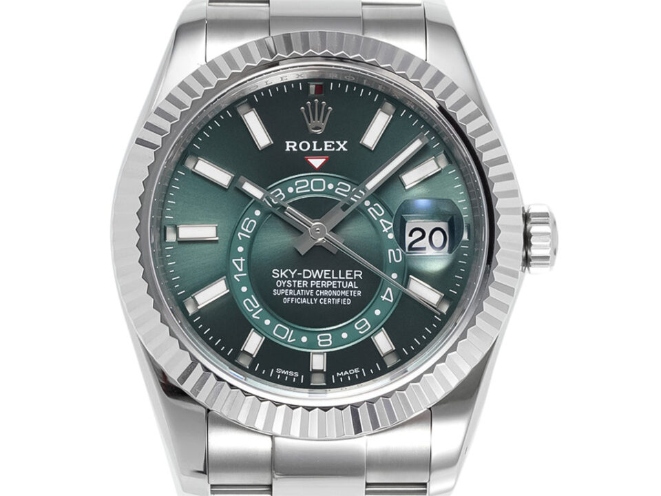Sky-Dweller Stainless Steel watch with green dial, fluted bezel, Oyster bracelet, and date display at 3 o'clock.