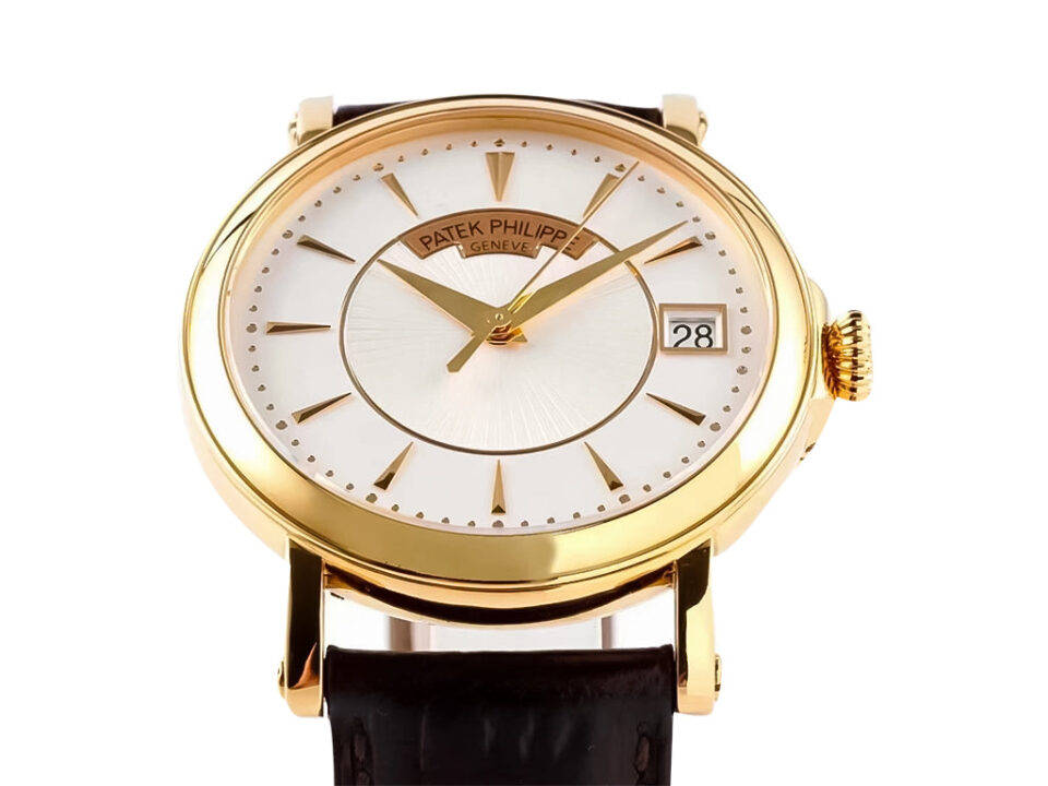 Calatrava Yellow Gold watch with a 38mm silver guilloché dial, gold hour markers, and black leather strap on display.