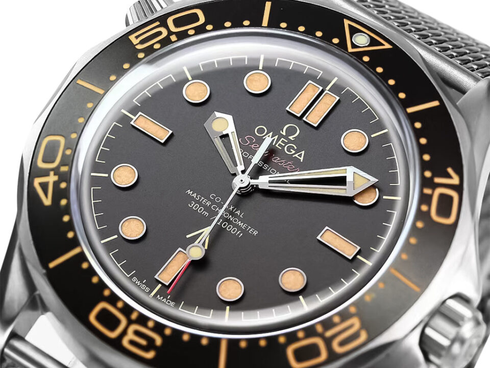 Close-up of the Seamaster Diver 300 Titanium ‘No Time to Die’ (42mm) watch face with a black dial and vintage-style indices.