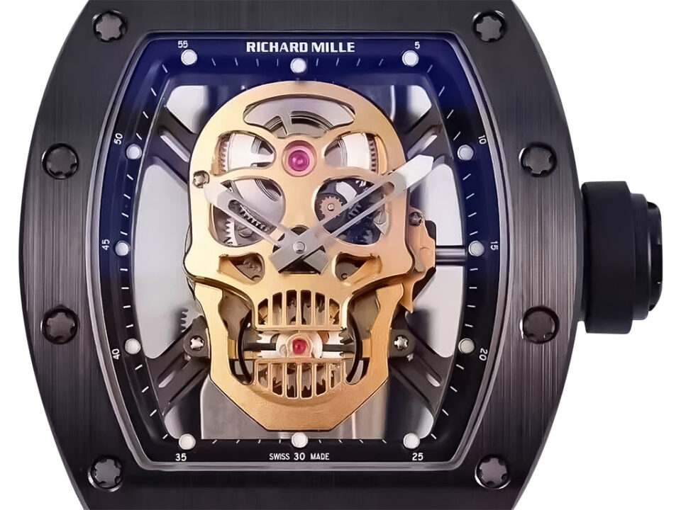 RM 52-01 Skull watch featuring black dial, black bezel, gold-tone skull motif, and black rubber strap; 50mm tourbillon.