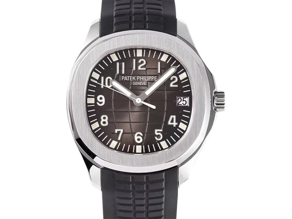 Aquanaut Stainless Steel 38mm watch with black embossed dial, white numerals, date display, and textured black rubber strap.