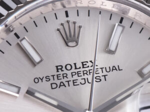 Close-up of the Datejust 36 Stainless Steel watch with Silver Dial, Fluted Bezel, Jubilee bracelet showing logo and markers.