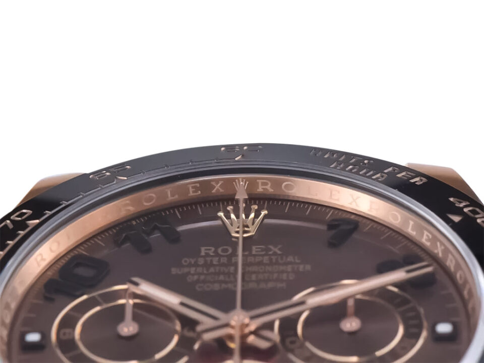 Cosmograph Daytona Rose Gold Oysterflex with Chocolate Dial featuring Arabic numerals, tachymeter scale, and elegant design.