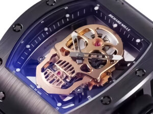 Alt text: Close-up of the RM 52-01 watch featuring a gold skull-shaped dial, black bezel, and tourbillon mechanism.