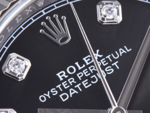 Close-up of Datejust 36 Stainless Steel on Jubilee with Diamond Black Dial, featuring fluted bezel and Rolex crown logo.