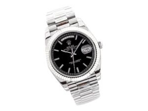 Day-Date 40 White Gold 'President' watch with a black dial, fluted bezel, and polished white gold bracelet displayed.