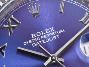 Close-up of the Datejust 41 Silver Dial with Roman numerals, fluted bezel, stainless steel Oyster bracelet displaying.