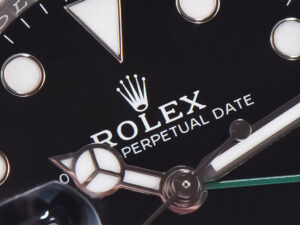 Close-up view of the dial of the GMT-Master II Stainless Steel 'Sprite' on Jubilee (40mm) showcasing branding and details.