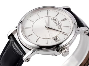 Calatrava Stainless Steel watch with a 38mm case, silver guilloche dial, sleek markers, and black leather strap.