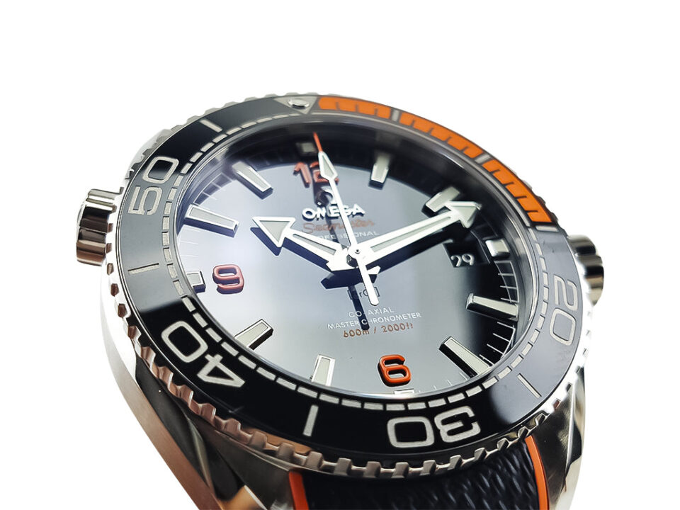 Seamaster Planet Ocean 600 watch with blue dial, rubber strap, and orange accents (43.5mm), showcasing bold design details.